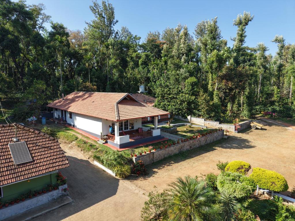 an overhead view of a house with a roof at Whispering Meadows By Dazzle Destinations - Coorg in Somvārpet