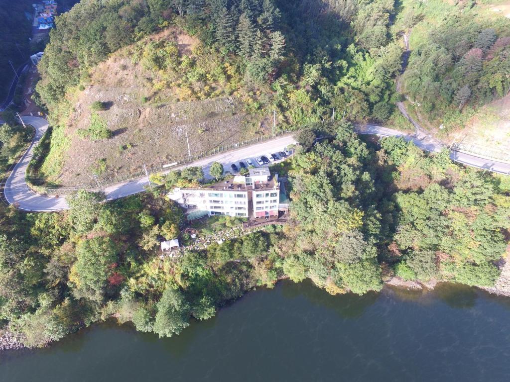 an aerial view of a house on an island in the water at Moonlight Blue Pension in Gapyeong