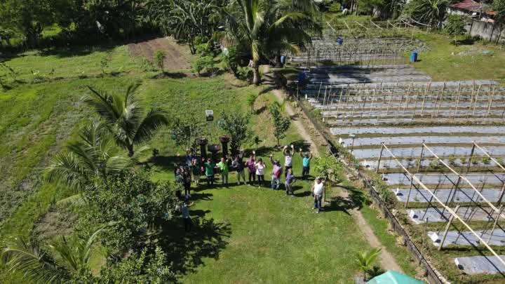 a group of people standing in the grass at PNAF Farm resort in Pililla