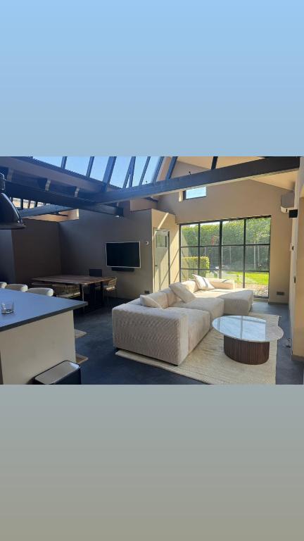 a large living room with two couches and a table at Schuurwoning in Weert