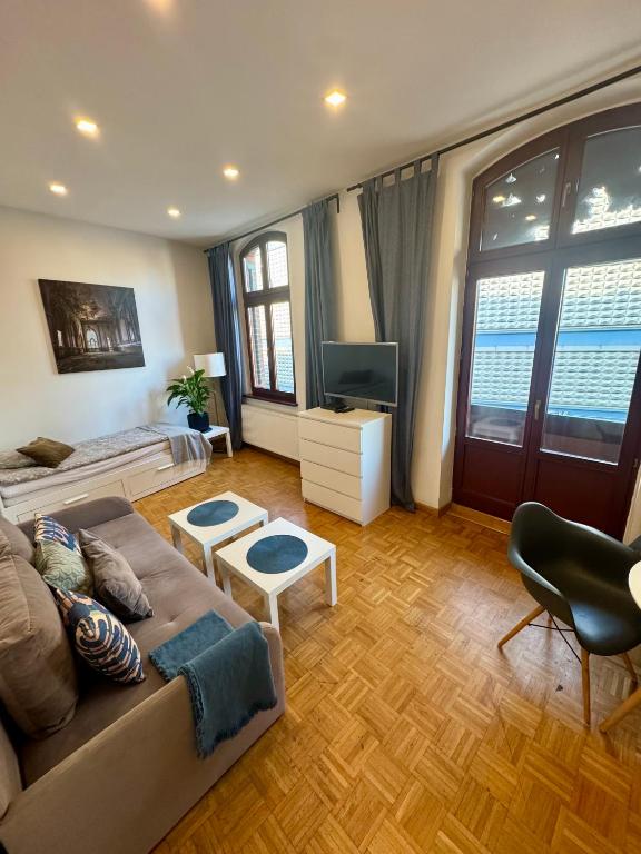 a living room with a couch and a television at LivingRoom 3 Family Self Check-in 24h in Katowice