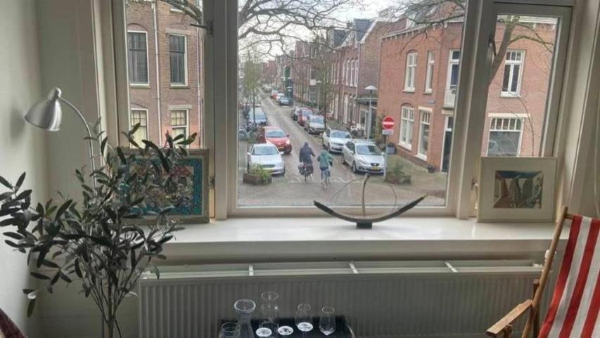a window with a view of a street with cars at Studio 11 in Utrecht