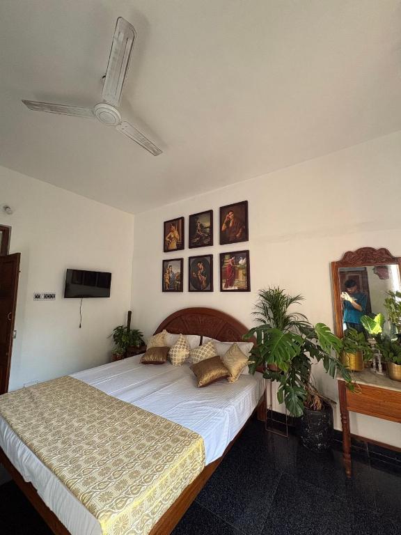 a bedroom with a large bed with pillows on it at Yaazhi Boutique Homestay in Pondicherry