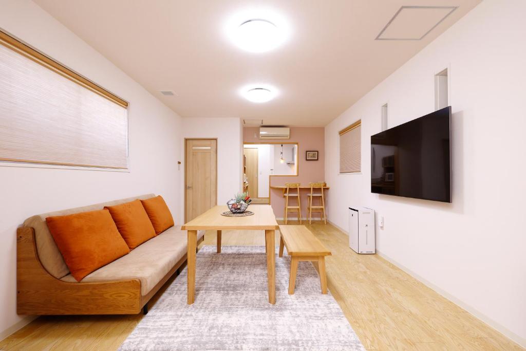 a living room with a couch and a table at 桜ノ舎 in Nara