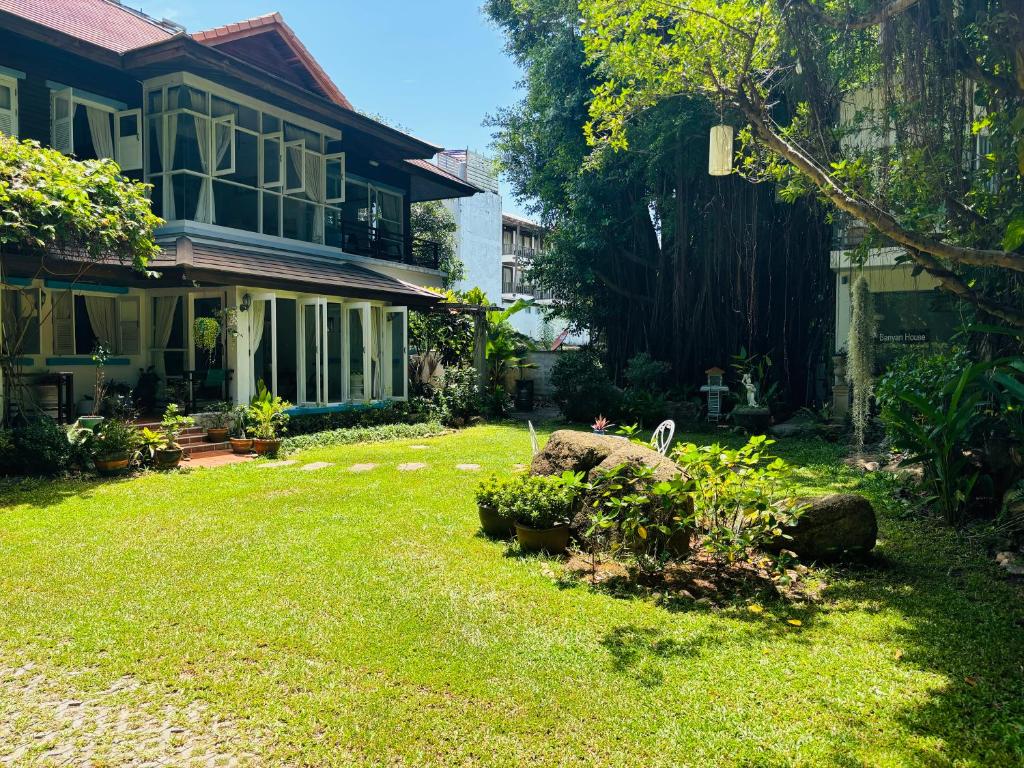 a yard of a house with a yard sidx sidx sidx at Banyan House Samui bed and breakfast (Adult Only) in Chaweng