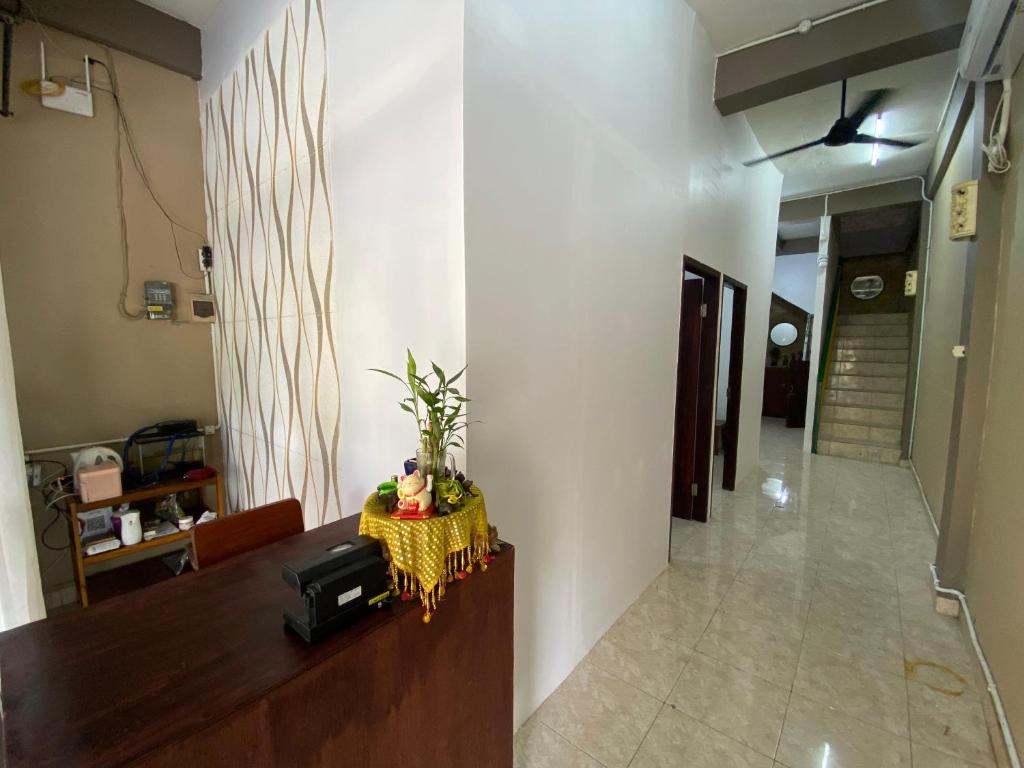 a living room with a table and a hallway at Ibu ana quest house in Tabanan