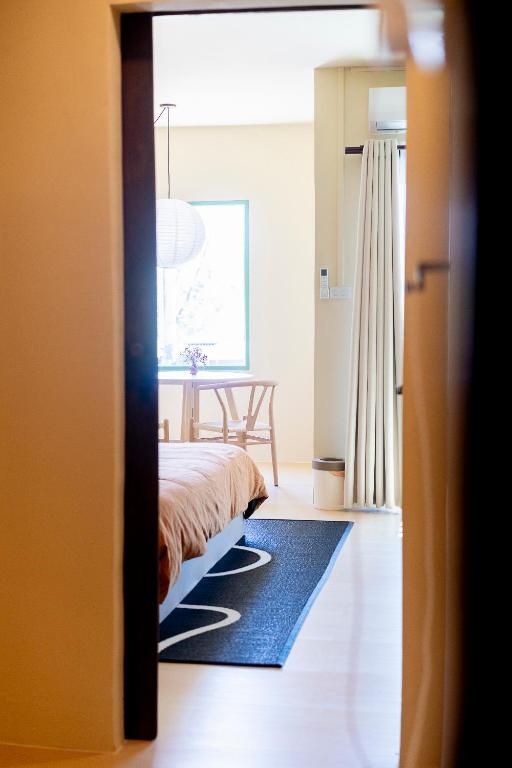 a bedroom with a bed and a blue rug at Oceanchild Khaolak in Khao Lak