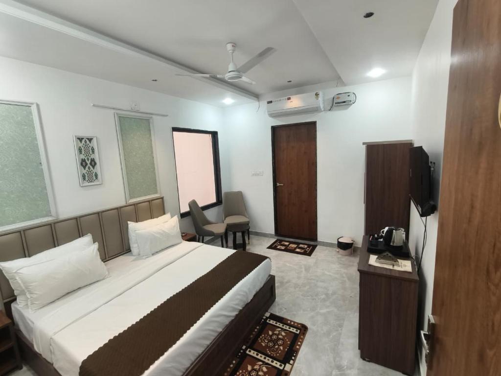 a bedroom with a bed and a television in a room at Hotel Yashoday in Kekri