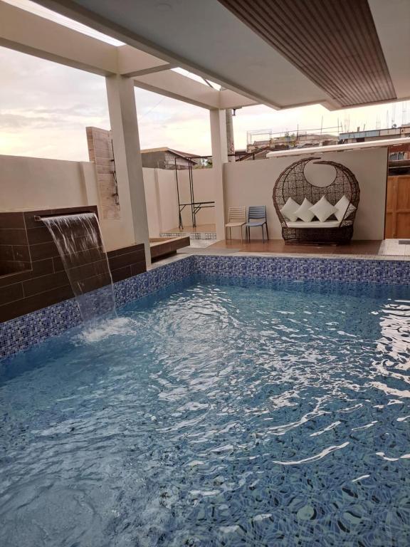 a swimming pool in the middle of a house at Maywood Private Resort in Calamba