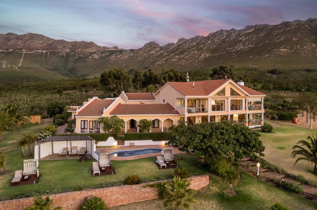 an aerial view of a house with a swimming pool at Apricot Gardens Guesthouse in Gordonʼs Bay
