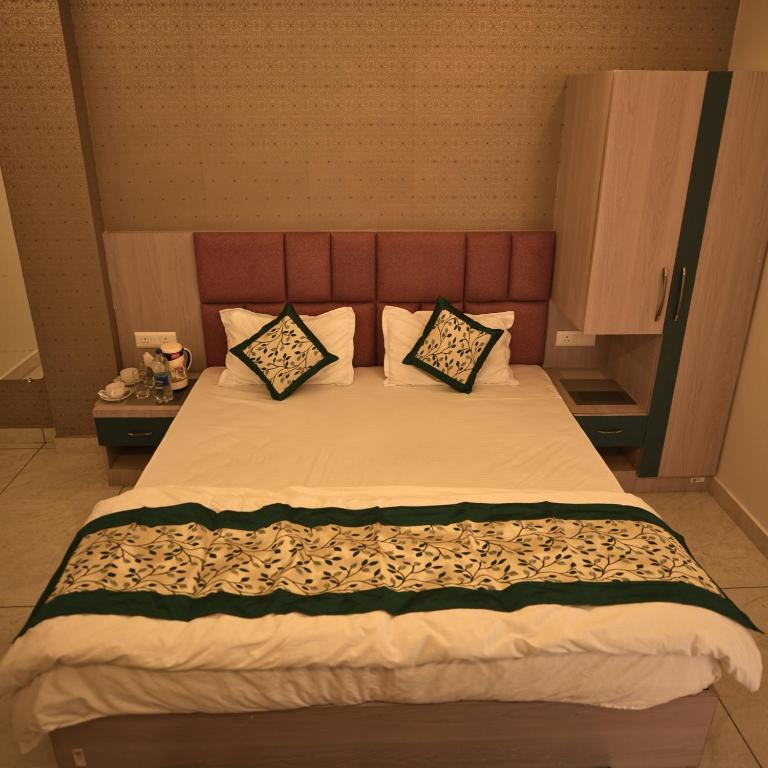 a bedroom with a large bed with two pillows at Mithila Resort in Jāmb