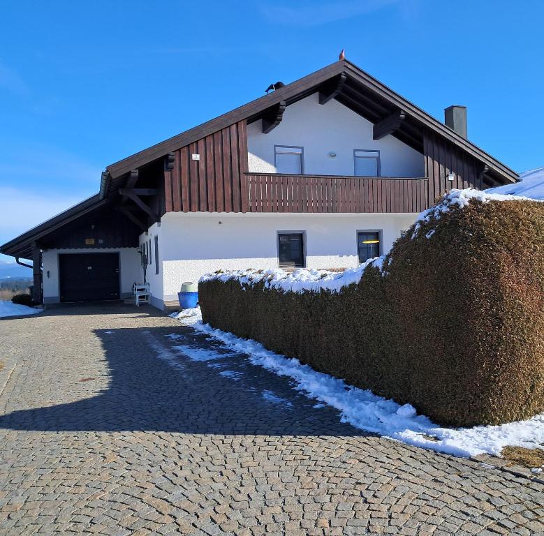 a building with a large hedge in front of it at Haus Probst in Bischofsmais