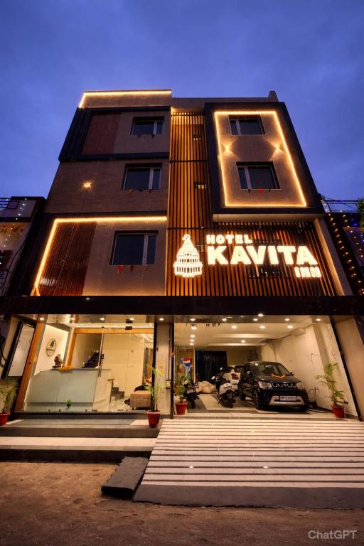 a building with a car parked in front of it at Hotel Kavita Inn in Ujjain