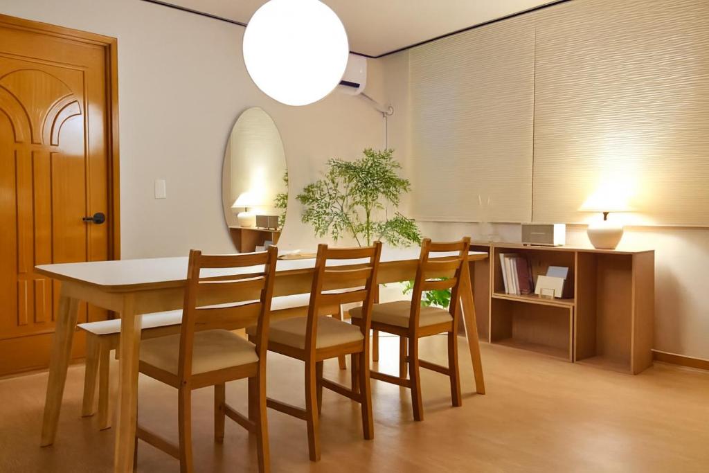 a dining room with a table and chairs at Sai-gil stay in Busan