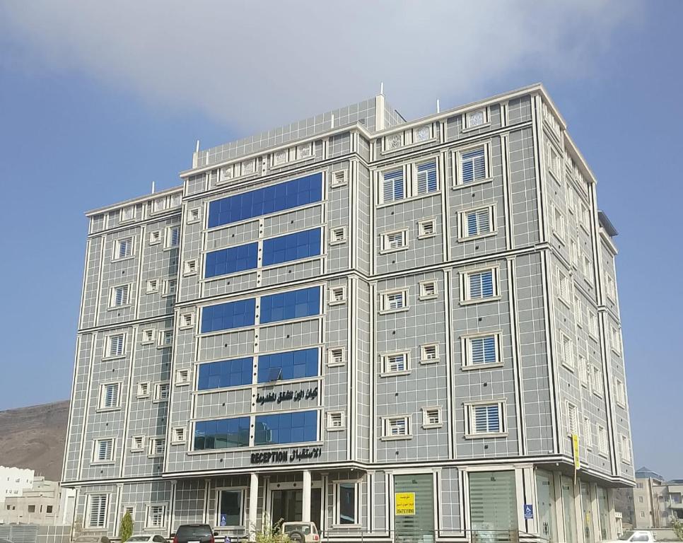 a large gray building with a lot of windows at كيان الين in Muhayil