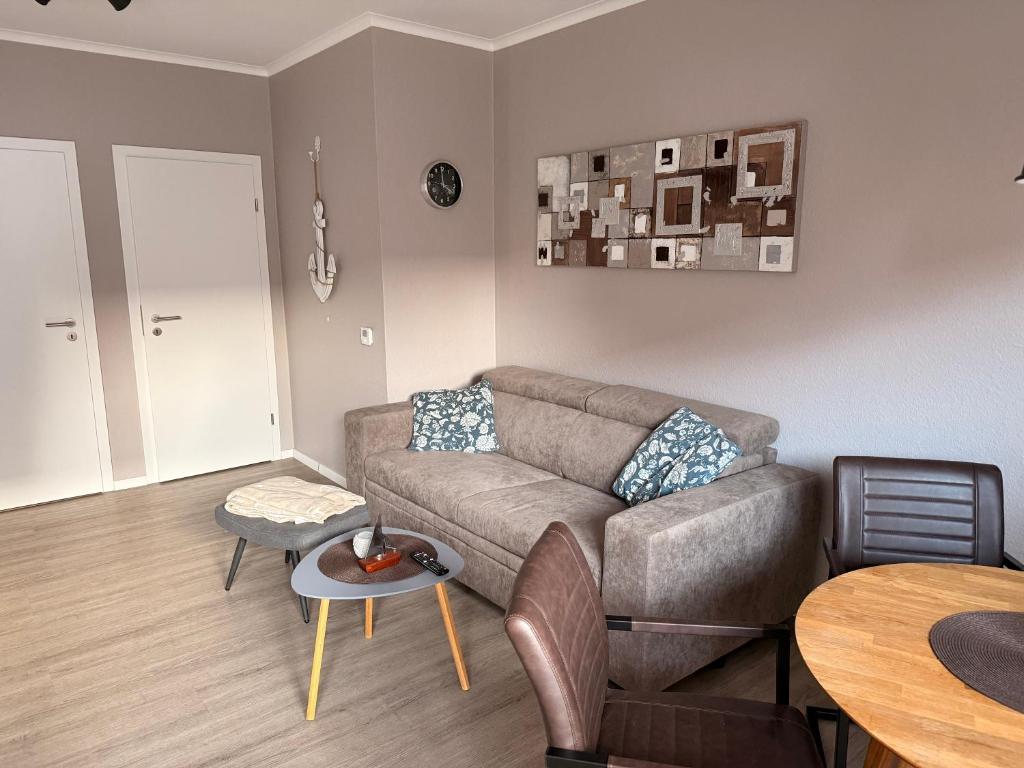 a living room with a couch and a table at Ankertau in Norden