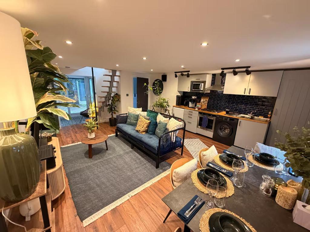 a living room with a couch and a table at Cozy Cottage Coventry self check-in after 3pm, Pets Friendly in Longford