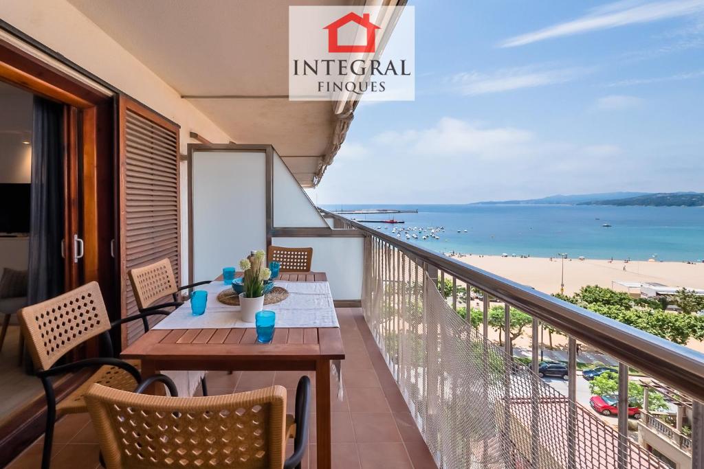 a balcony with a table and chairs and a view of the beach at Palamós Blue Holidays in Palamós