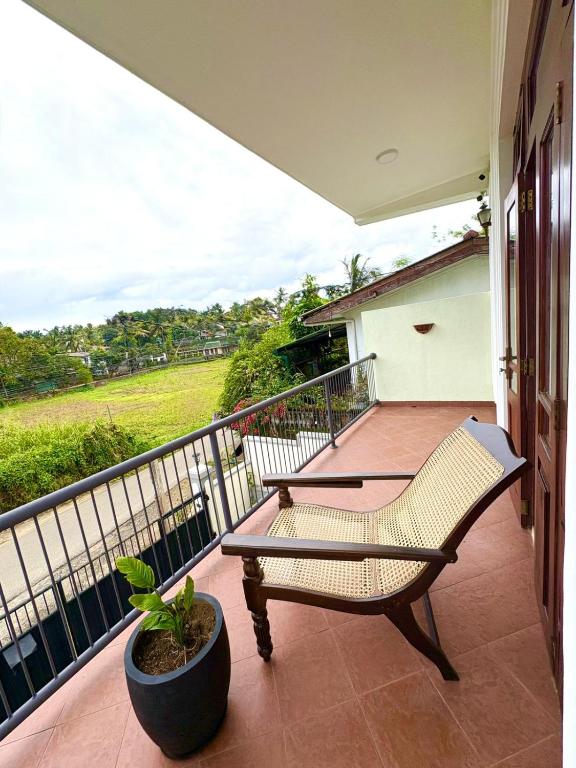 a balcony with a bench and a potted plant at The Kandy City Townhouse in Kandy