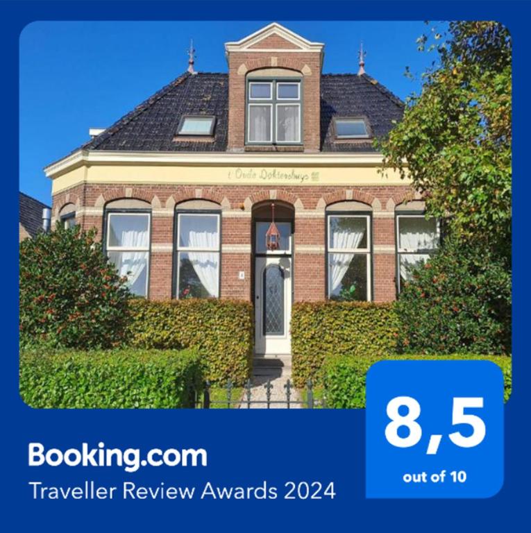 a brick house with the words travel review awards at B&B Het Oude Doktershuys in Minnertsga