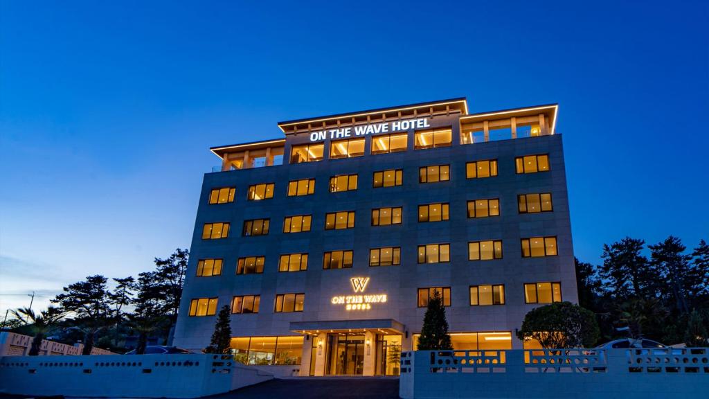a building with the words on the wine hotel at 온더웨이브호텔 in Taesong