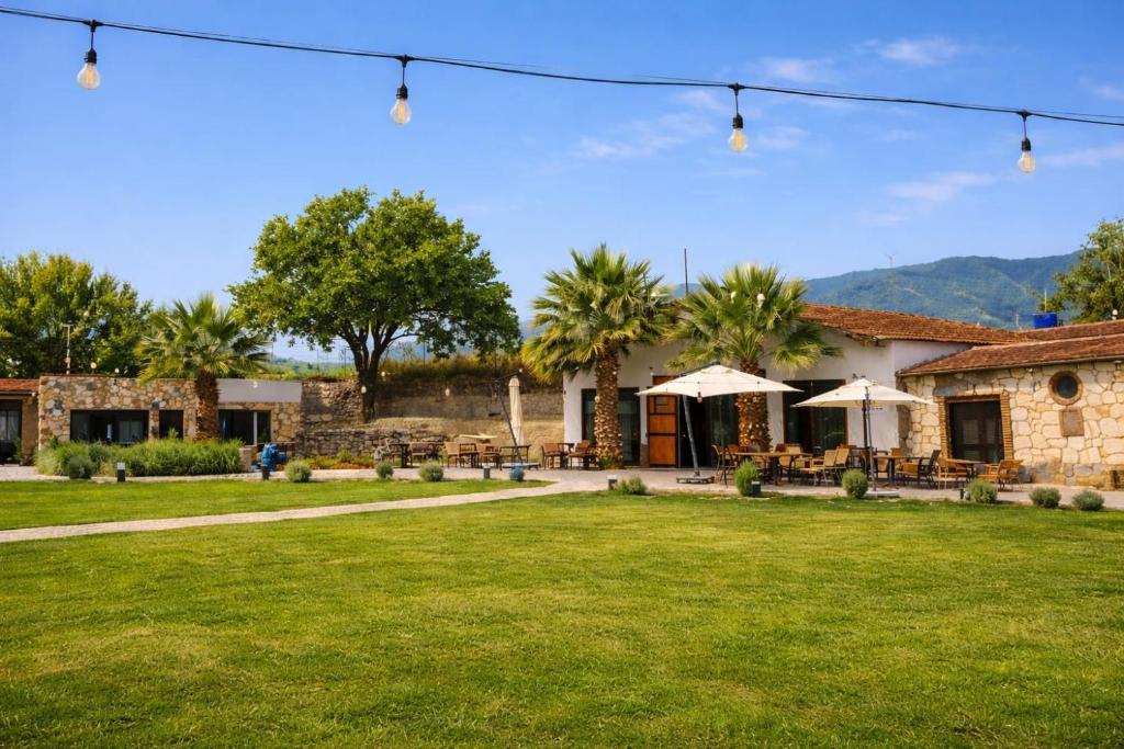 a house with a lawn in front of it at Erdem Ciftligi/ Ephesus Arena in Selçuk