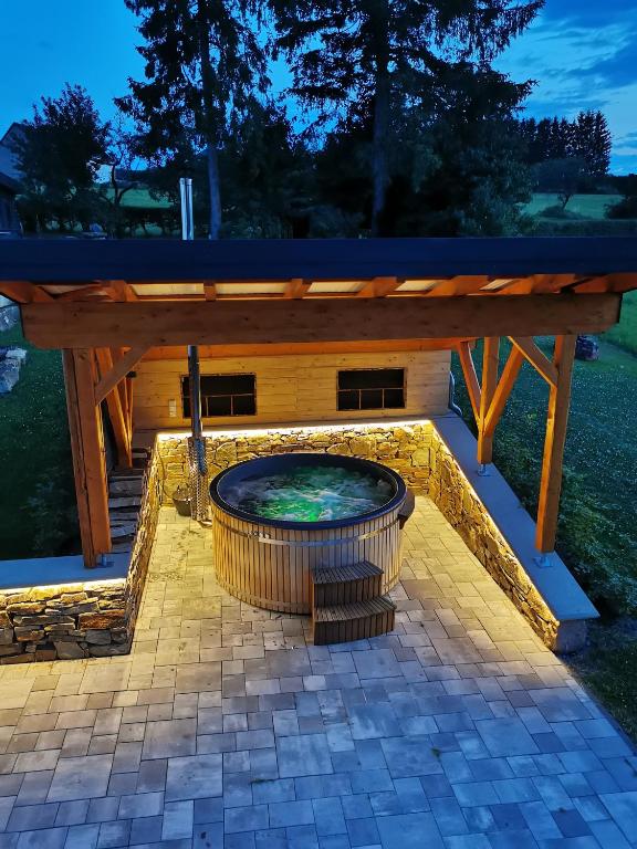 a wooden pergola with a fire pit under it at Auwer Hills - On dr Schür in Auw