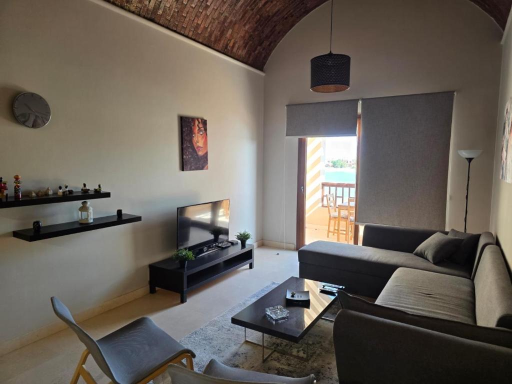 a living room with a couch and a table at Blue haven el gouna in Hurghada