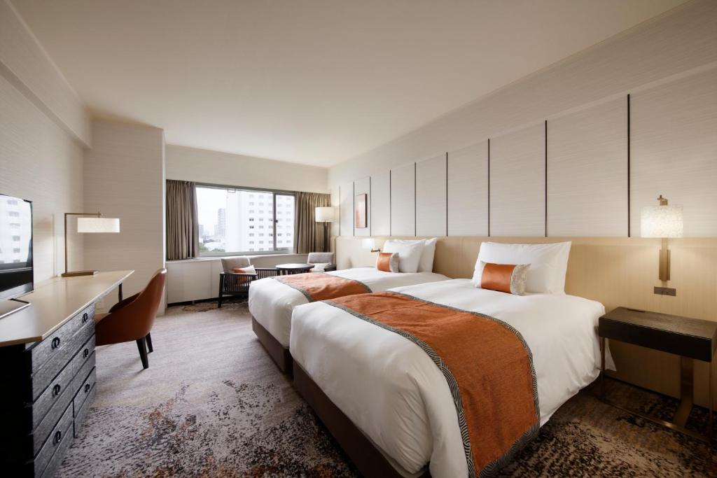 a large hotel room with a large bed and a television at Grand Prince Hotel Takanawa in Tokyo