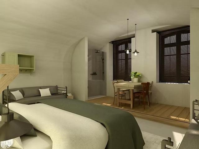 a bedroom with a bed and a dining room with a table at Erflogies Fort Liezele in Puursheide