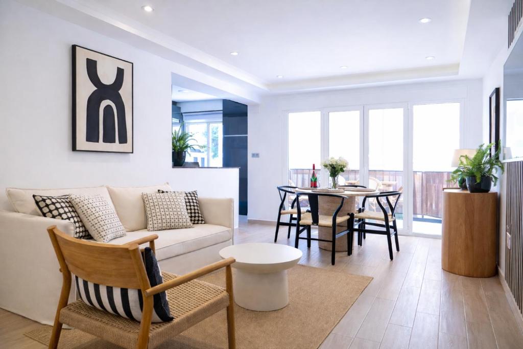 a living room with a couch and a table at Central Torremolinos Luxury Apartment in Torremolinos