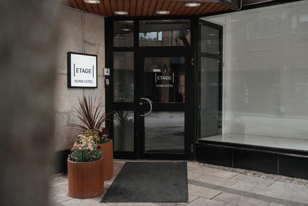 an entrance to a building with a glass door at Home Hotel Etage in Västerås
