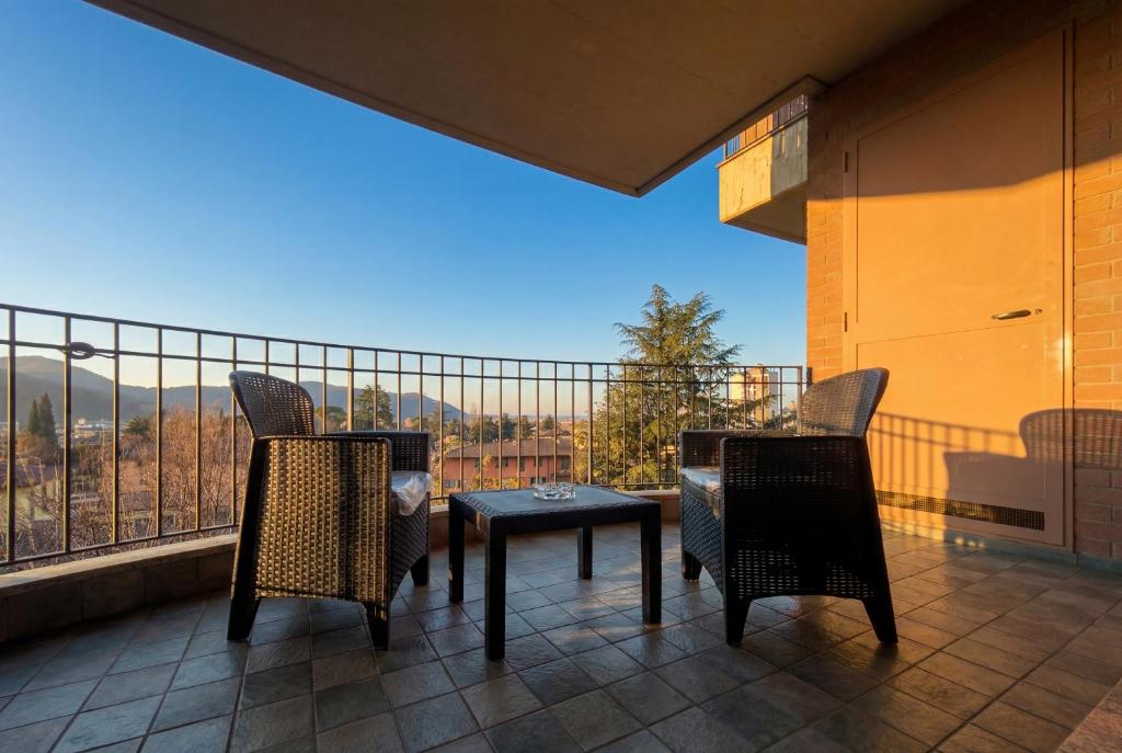 a balcony with a table and chairs and a view at Dreamescape House in Alzano Lombardo