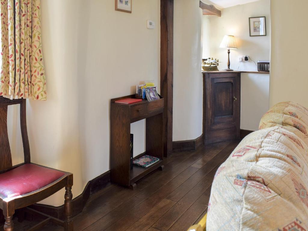a room with a couch and a chair and a table at Stable Cottage in Windermere