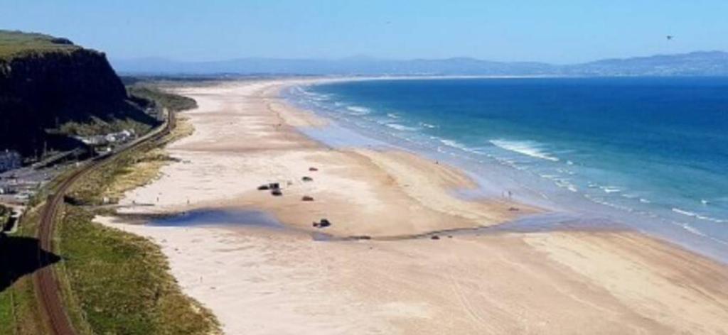 an aerial view of a beach next to the ocean at Downhill Beach Studio Suite in Coleraine