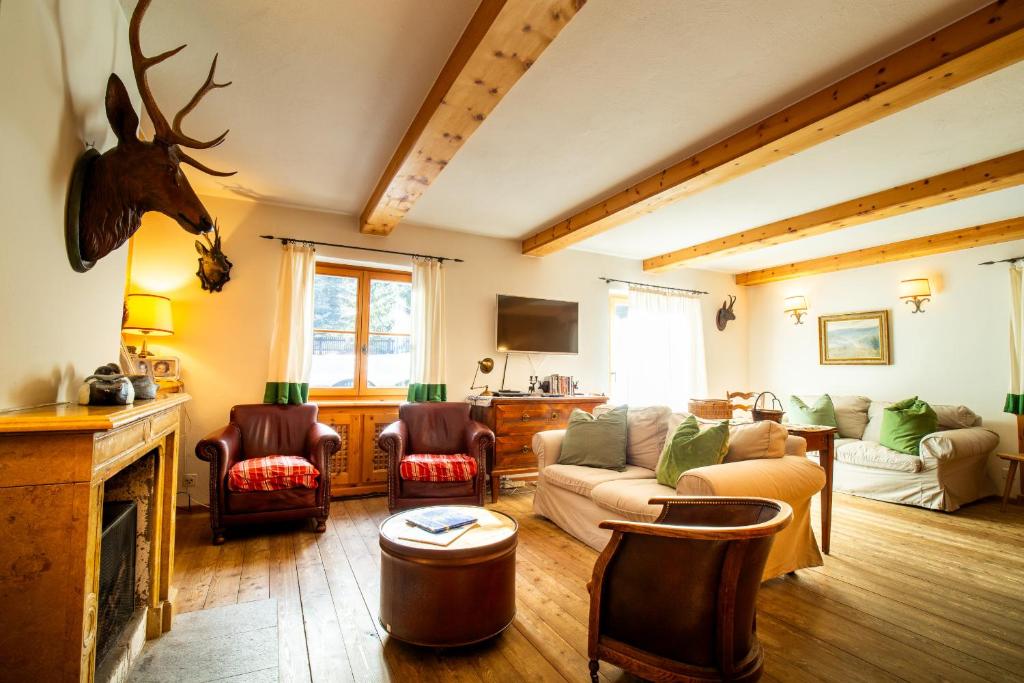 a living room with a couch and chairs at Chalet Gulas - La Punt-Chamues-ch in La Punt-Chamues-ch