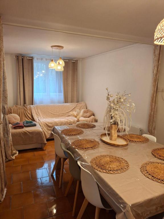 a living room with a table and a couch at maison village 3 chambres 30 minutes du zoo de beauval in Saint-Cyran-du-Jambot