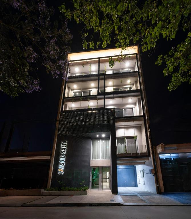 a tall building with lights in the night at Cañada Suites by FMA Coliving in Salta
