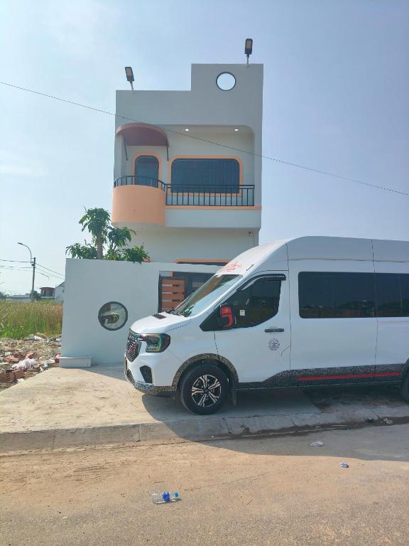 a white van parked in front of a building at Cherry House villa in Hà Tiên