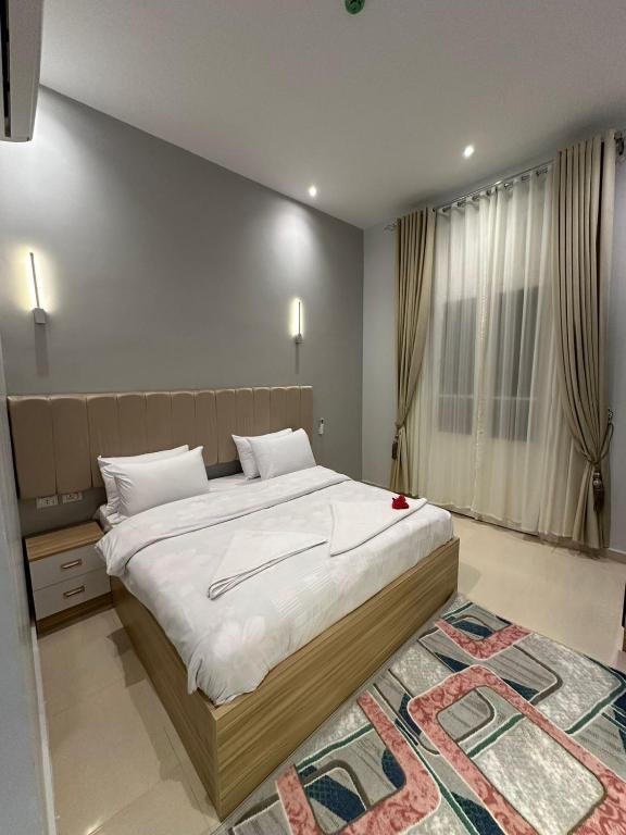 castello hotel في القاهرة: غرفة نوم بها سرير كبير ذو ملاءات بيضاء