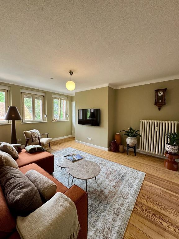 a living room with a couch and a table at Boutique Apartment Villa Jaenisch in Kaiserslautern