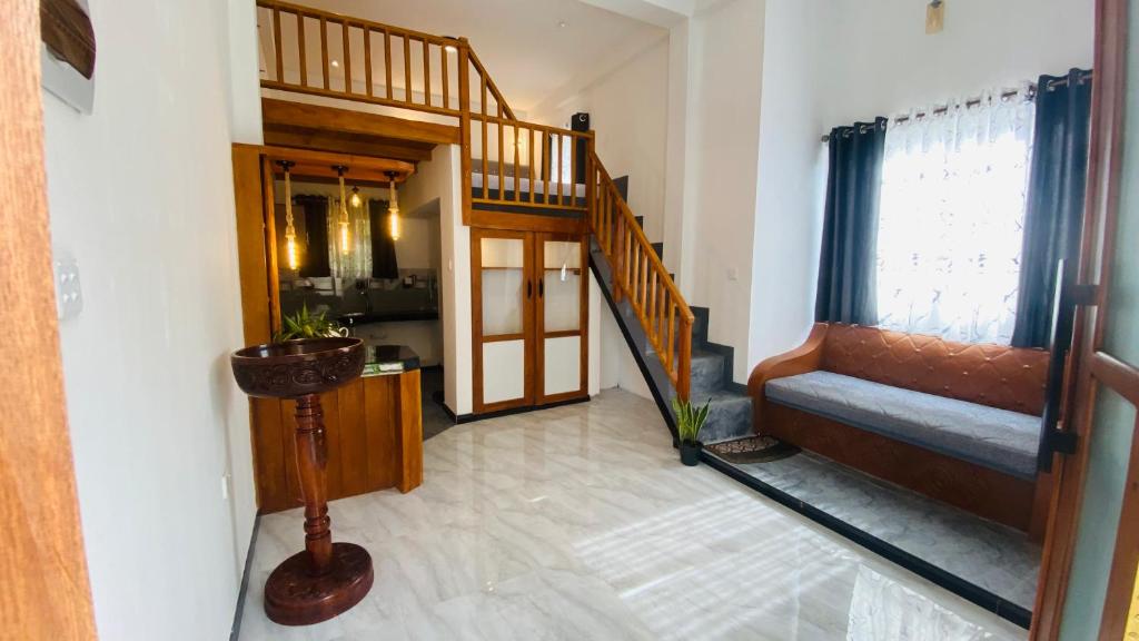 a living room with a staircase and a stair case at Coco Wave Midigama in Midigama East
