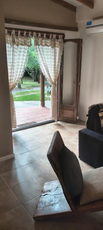 a living room with a couch and a large window at Paraíso Serrano in Casa Grande