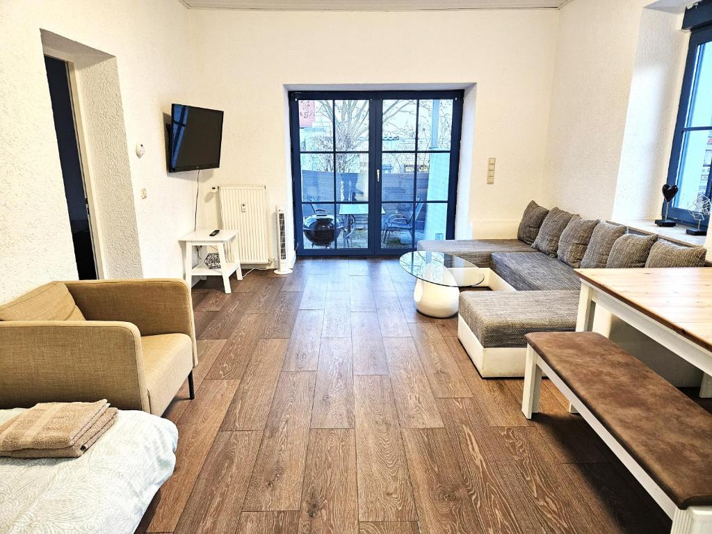 a living room with a couch and a table at Monteur Oase Leipzig Nord in Schkeuditz