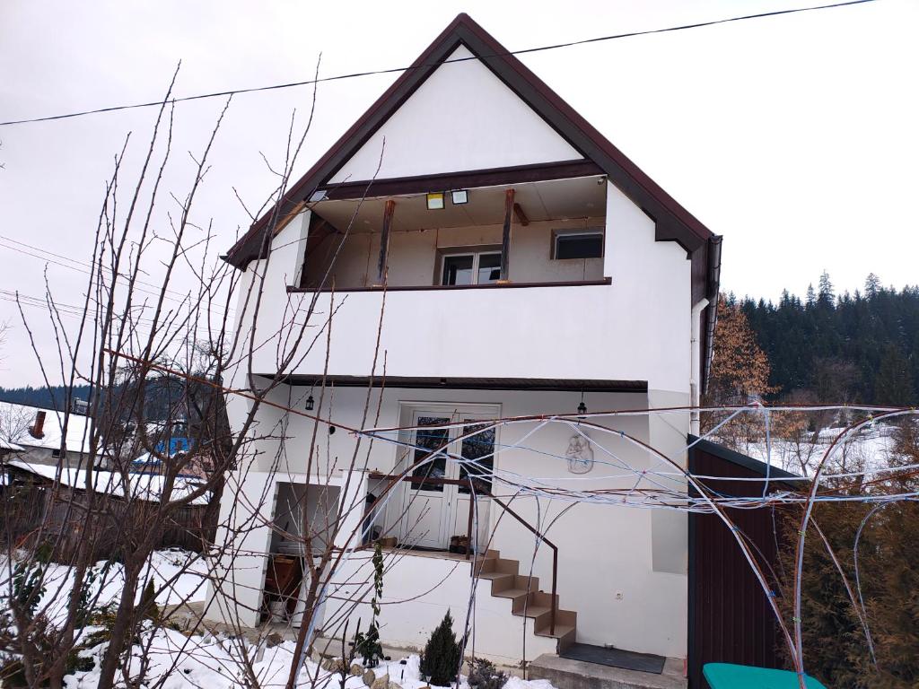 a white house with a window and some stairs at Panaghie in Hangul