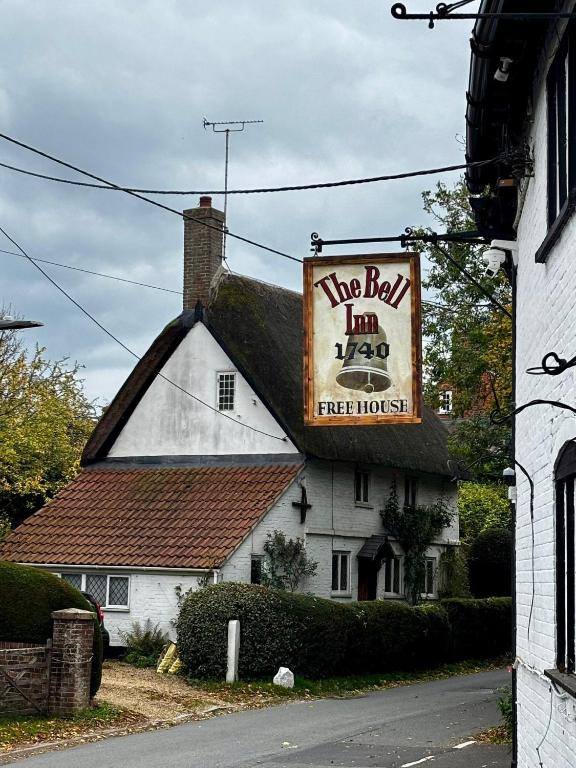 a building with a sign for a hog belt inn at The Bell Inn in Devizes