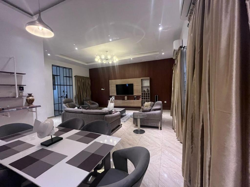 a large living room with a table and chairs at Lekki Waterfront Terrace shortlet with Oceanview, Attendants and private Jetty in Lagos