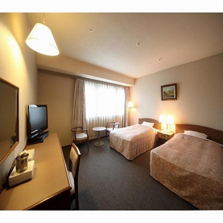 Postel nebo postele na pokoji v ubytování Hotel Crown Hills Takefu