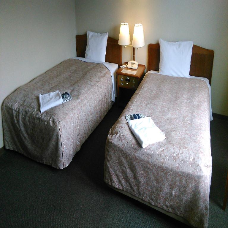 Postel nebo postele na pokoji v ubytování Hotel Crown Hills Takefu