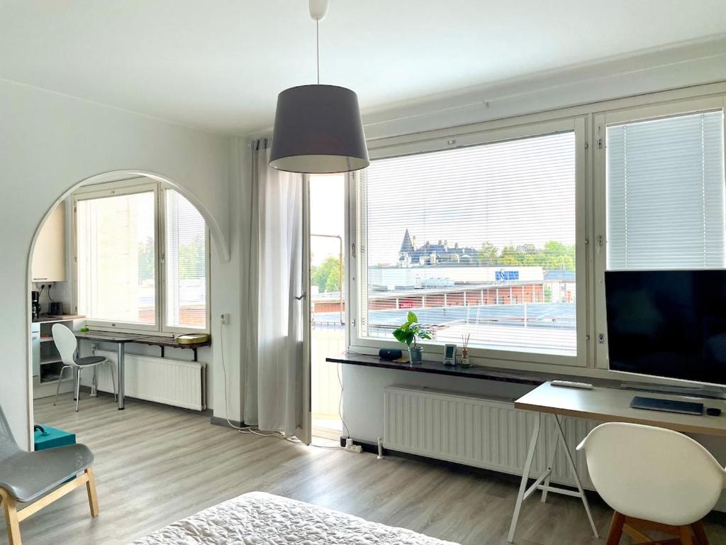 a living room with a tv and a large window at Centerpoint Imatra in Imatra